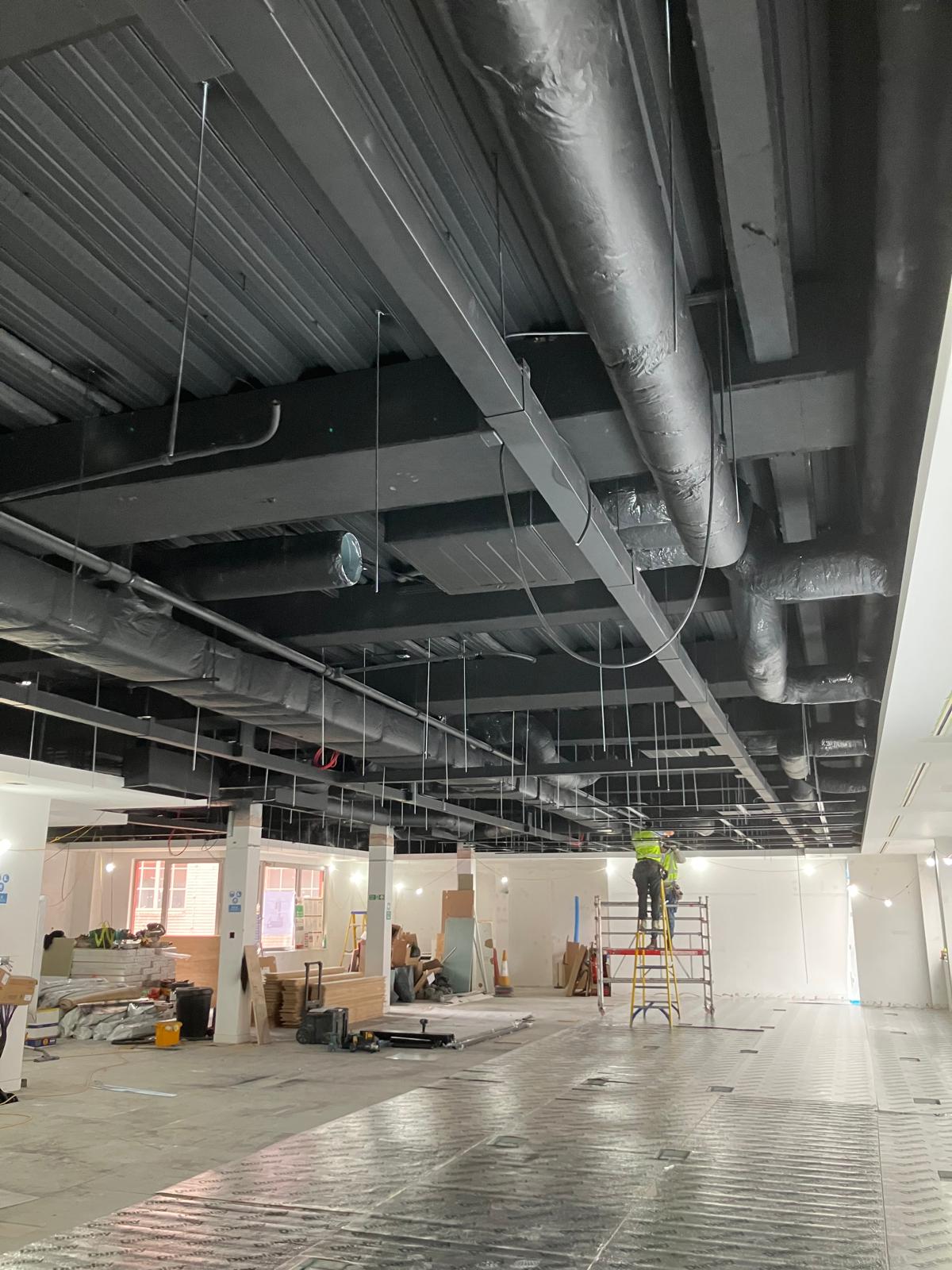 Open plan area with M&E services and ceiling grid